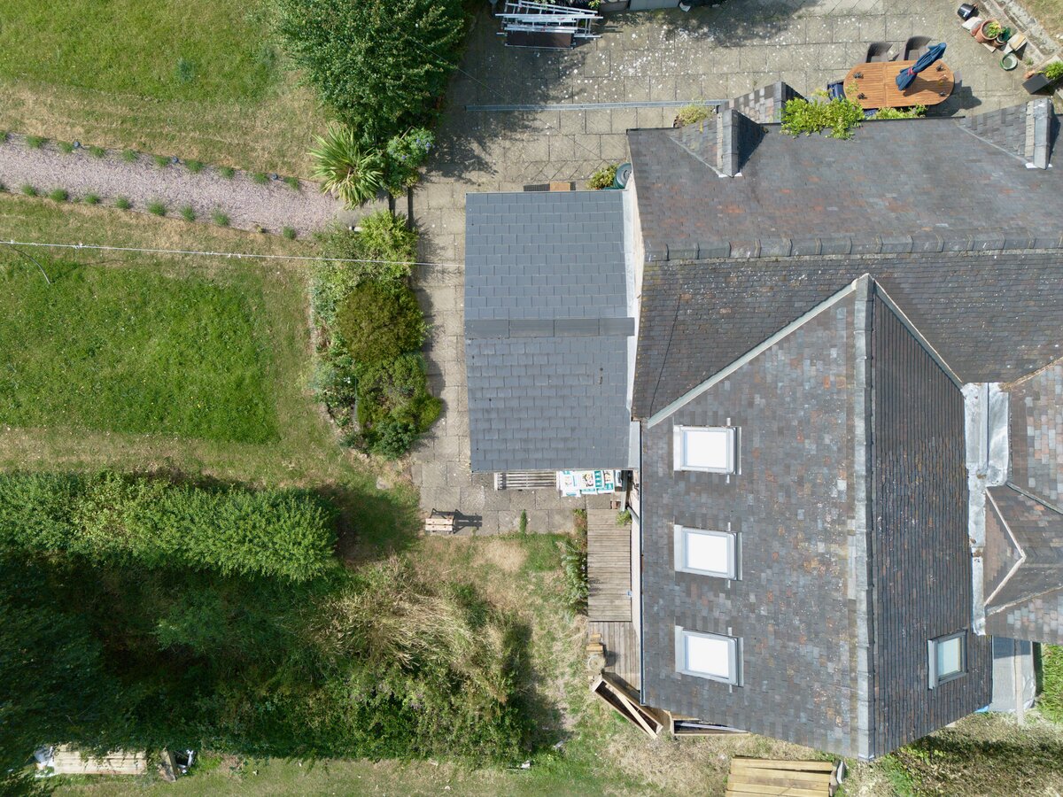 Aerial view of a rural estate roof and adjoining property