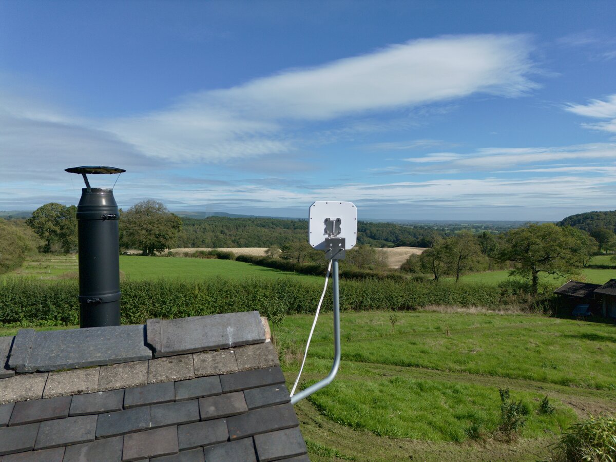 Installed directional 5G antenna overlooking a rural landscape