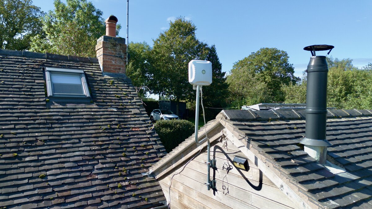 Installed directional 5G antenna mounted above a rural property roof