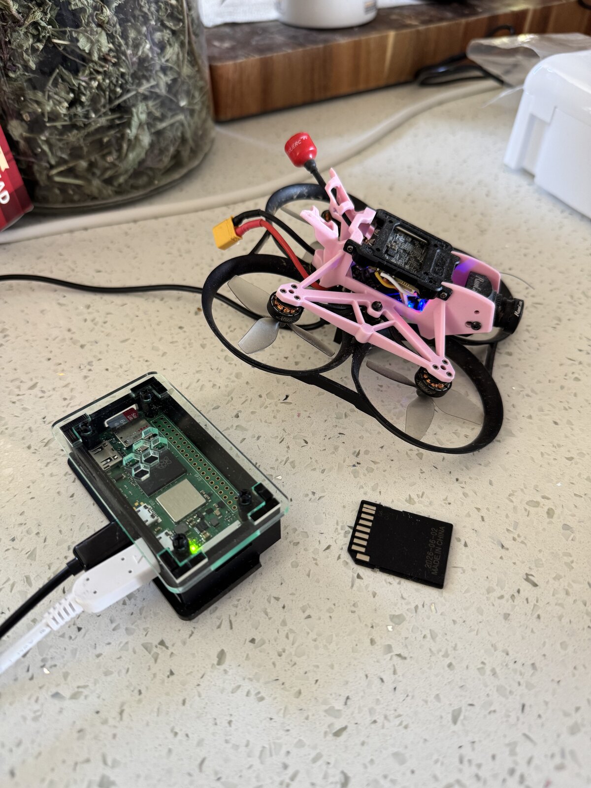 LogFalcon beside a custom-built GEPRC Darkstar 20 FPV drone